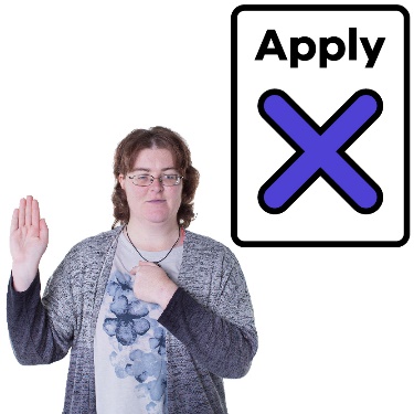 A woman with disability pointing to herself and raising her hand. There is an application document with a cross on it next to her.