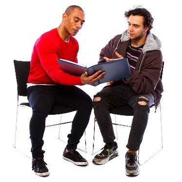 2 men looking at a document together.