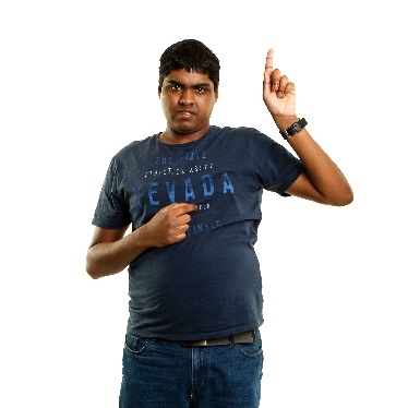 A student with disability pointing to himself and raising a hand.